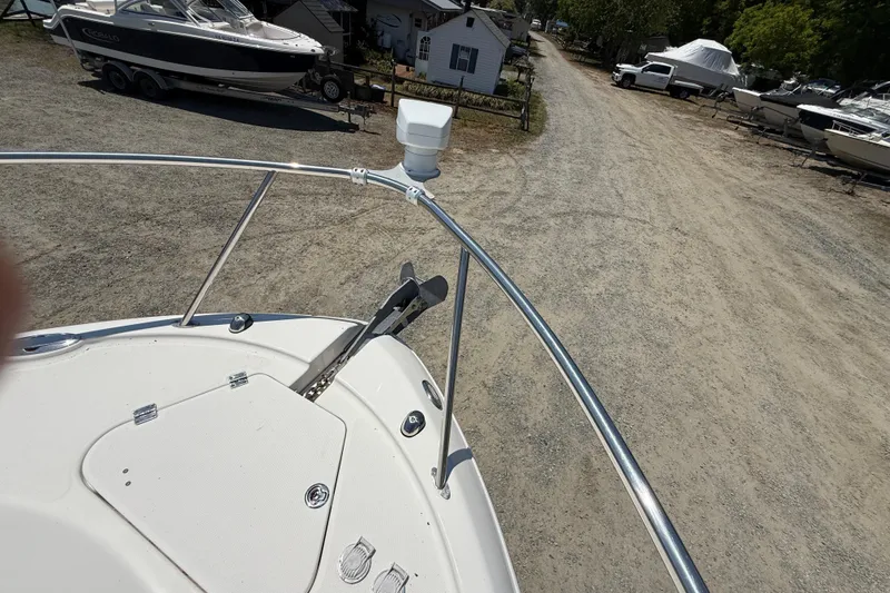 Slide: The Image of Bow view of 2007 Robalo R305 Walkaround boat in a marina setting. - 15