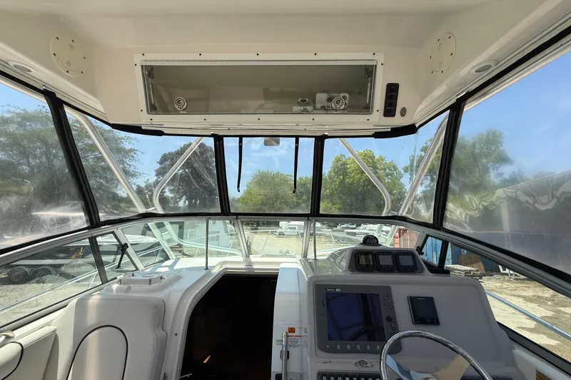 Slide: The Image of 2007 Robalo R305 Walkaround boat cockpit with steering wheel and navigation equipment. - 16