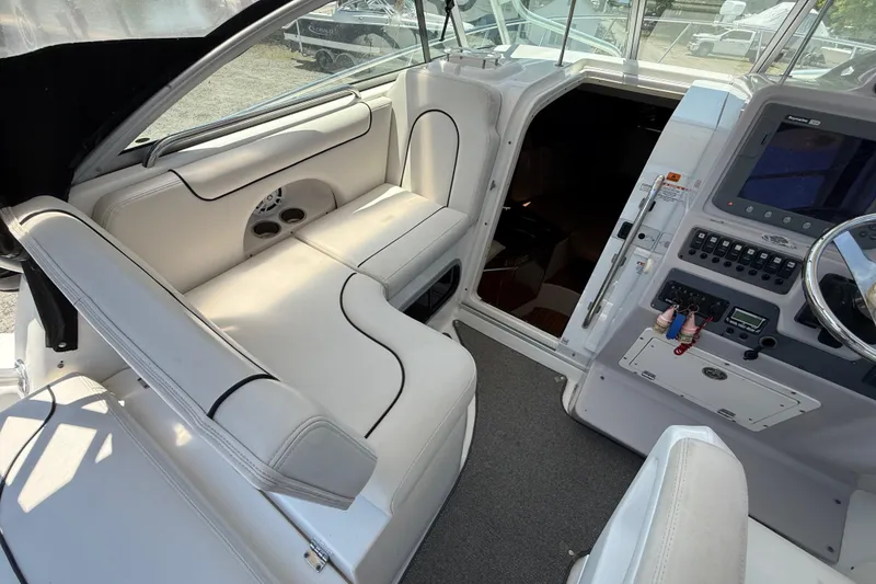 Slide: The Image of 2007 Robalo R305 Walkaround boat interior with white seating and control panel. - 17