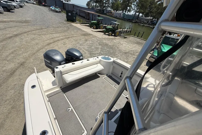 Slide: The Image of 2007 Robalo R305 Walkaround boat with Yamaha engines at a marina. - 18