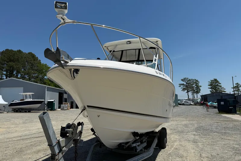 Slide: The Image of 2007 Robalo R305 Walkaround boat on trailer in outdoor storage area. - 24
