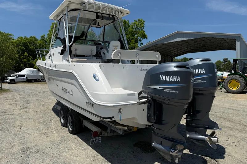 Slide: The Image of 2007 Robalo R305 Walkaround boat with twin Yamaha engines on a trailer. - 26