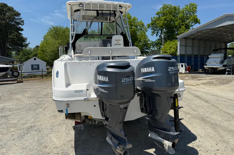 Slide: The Image of 2007 Robalo R305 Walkaround boat with twin Yamaha 250 engines, parked outdoors. - 29