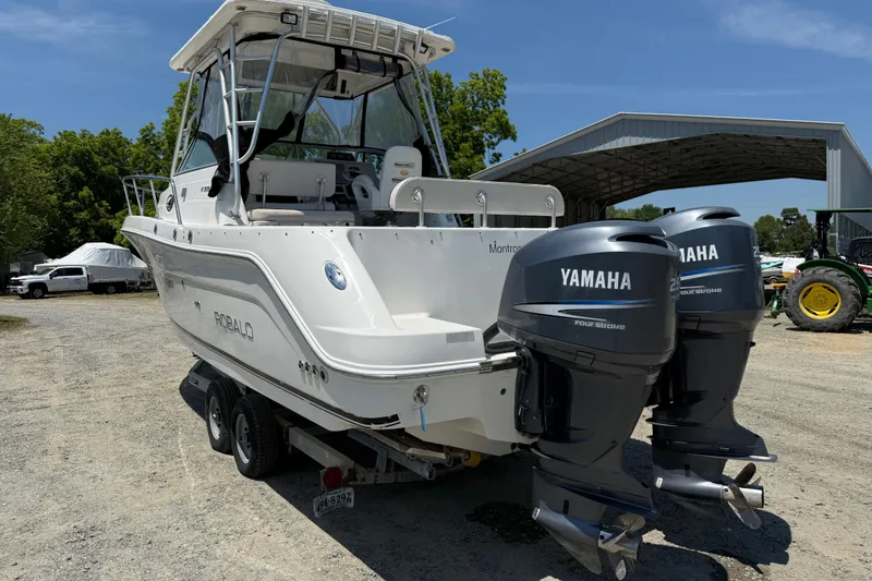 Slide: The Image of 2007 Robalo R305 Walkaround boat with dual Yamaha engines on a trailer. - 30
