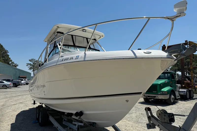 Slide: The Image of 2007 Robalo R305 Walkaround boat on trailer in sunny outdoor setting. - 4