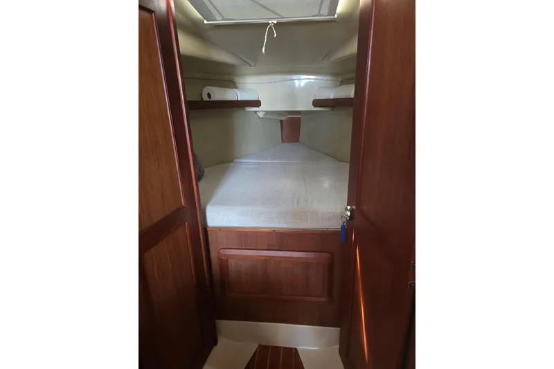 Slide: The Image of 1993 Hunter Legend 35.5 yacht cabin interior with wooden finish and cozy bed. - 17