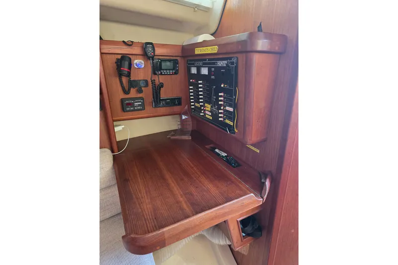 Slide: The Image of Navigation station of a 1993 Hunter Legend 35.5 sailboat with control panel and radio equipment. - 26