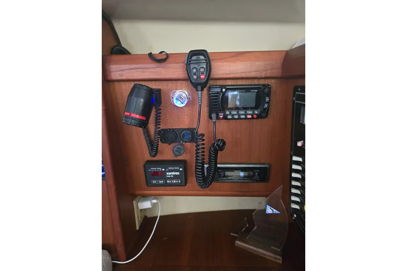 Slide: The Image of Control panel of a 1993 Hunter Legend 35.5 sailboat with communication equipment. - 28