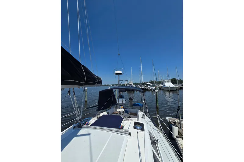 Slide: The Image of Sailboat Hunter Legend 35.5, 1993 model, docked in a marina under clear blue skies. - 32
