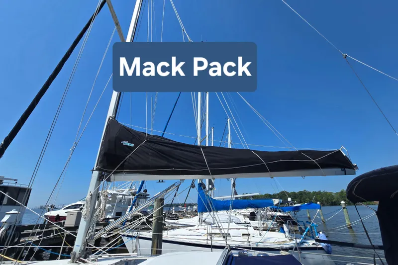Slide: The Image of Sailboat with Mack Pack sail cover, Hunter Legend 35.5, 1993 model, docked under clear sky. - 4