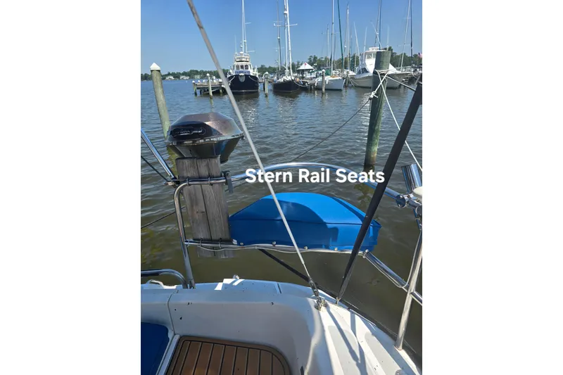 Slide: The Image of Hunter Legend 35.5 sailboat with stern rail seats, docked in a marina, 1993 model. - 7