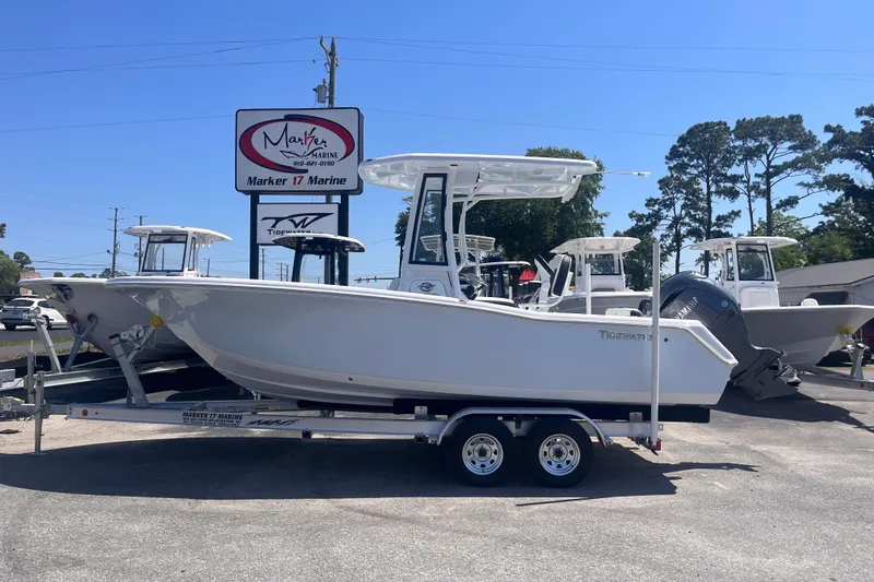 The Image of 2026 Tidewater 220 CC Adventure boat on trailer at Marker 17 Marine dealership. - 0