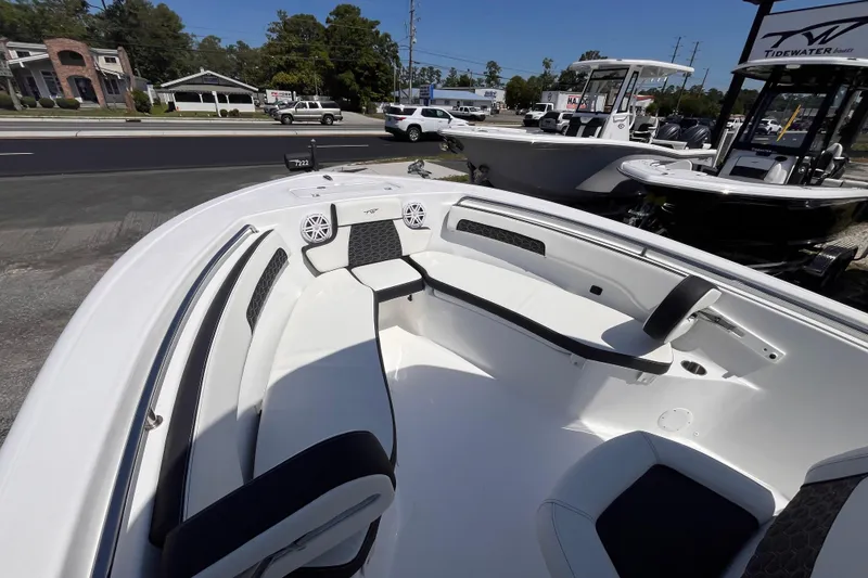 Slide: The Image of 2026 Tidewater 220 CC Adventure boat interior with seating and speakers, displayed outdoors. - 12