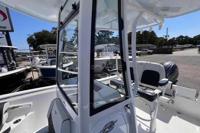 Slide: The Image of 2026 Tidewater 220 CC Adventure boat with Yamaha engine, showcased outdoors. - 13