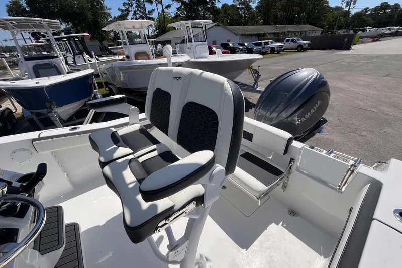 Slide: The Image of 2026 Tidewater 220 CC Adventure boat interior with Yamaha engine, showcasing seating and controls. - 14