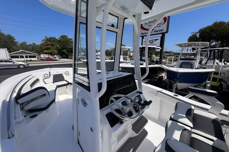 Slide: The Image of 2026 Tidewater 220 CC Adventure boat interior with modern helm and seating. - 15