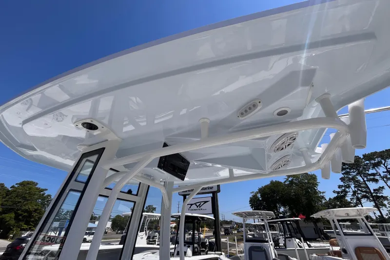 Slide: The Image of 2026 Tidewater 220 CC Adventure boat with T-top and speakers, viewed from below. - 16