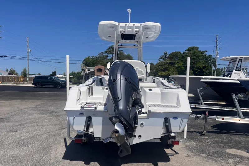 Slide: The Image of 2026 Tidewater 220 CC Adventure boat with powerful outboard motor, parked outdoors. - 3