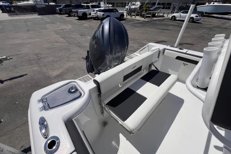 Slide: The Image of 2026 Tidewater 220 CC Adventure boat with seating and motor in a marina. - 6