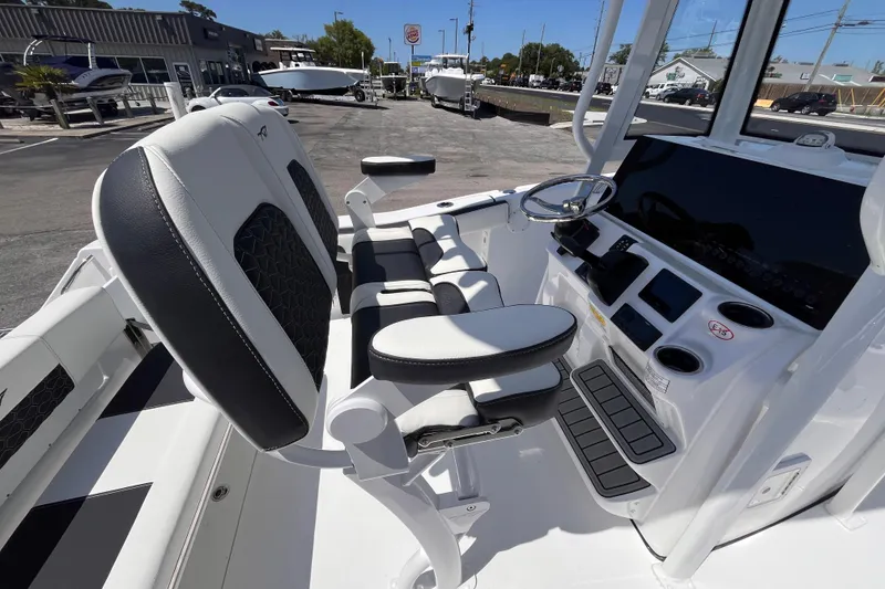 Slide: The Image of 2026 Tidewater 220 CC Adventure boat cockpit with modern helm and seating. - 7