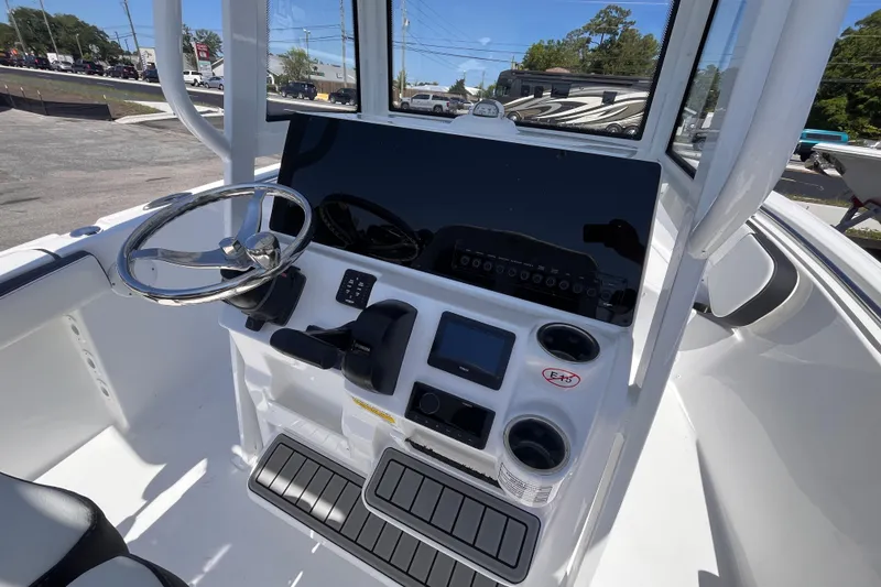 Slide: The Image of 2026 Tidewater 220 CC Adventure boat console with steering wheel and controls. - 8
