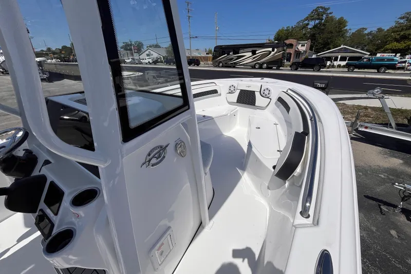 Slide: The Image of 2026 Tidewater 220 CC Adventure boat interior with seating and console view. - 9