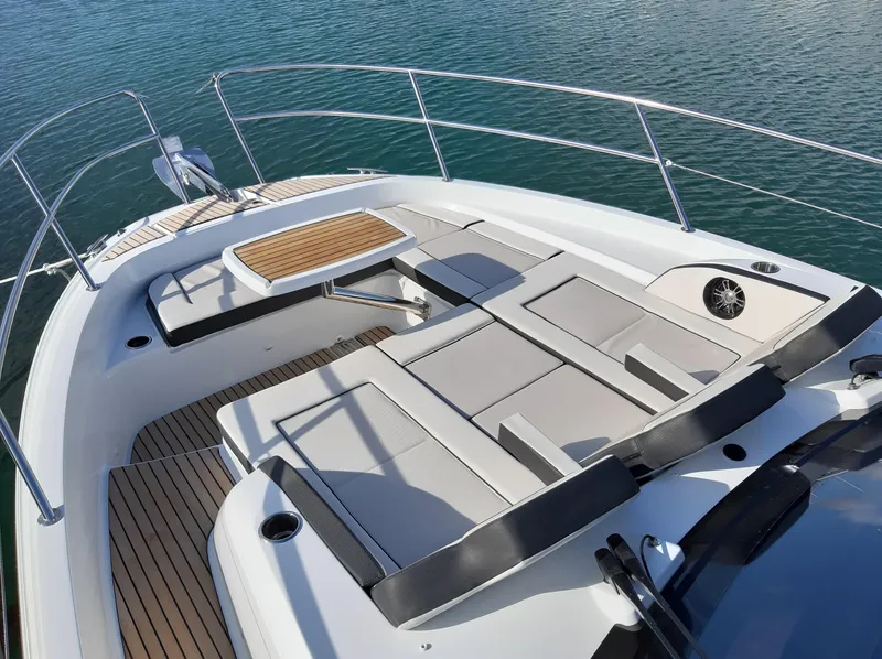 Slide: The Image of 2024 Jeanneau Leader 12.5 WA boat with spacious deck and seating area on water. - 14