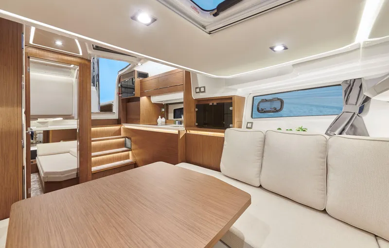 Slide: The Image of 2024 Jeanneau Leader 12.5 WA interior with modern design, wood finishes, and comfortable seating. - 16