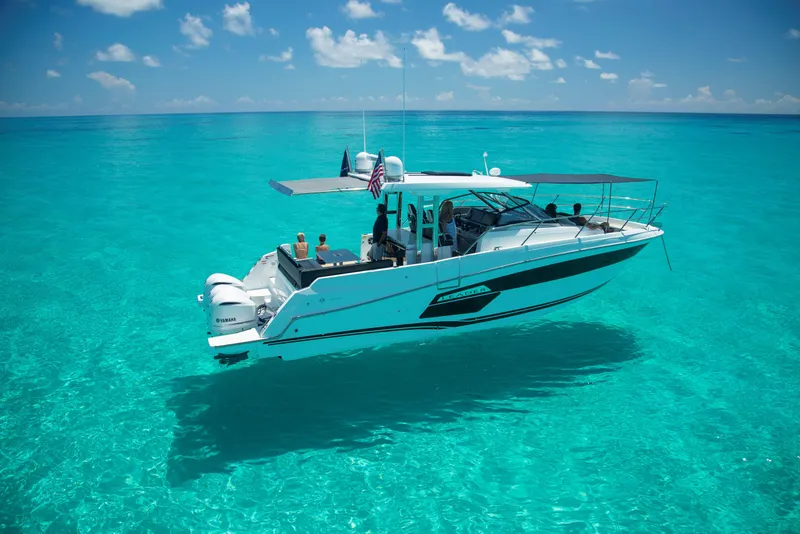 Slide: The Image of 2024 Jeanneau Leader 12.5 WA cruising on clear turquoise waters under a sunny sky. - 3