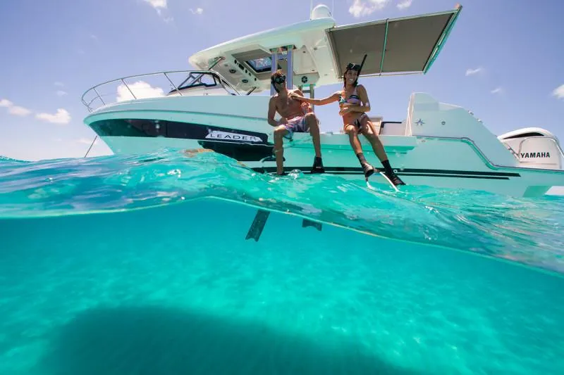 Slide: The Image of 2024 Jeanneau Leader 12.5 WA boat with snorkelers in clear turquoise water. - 6