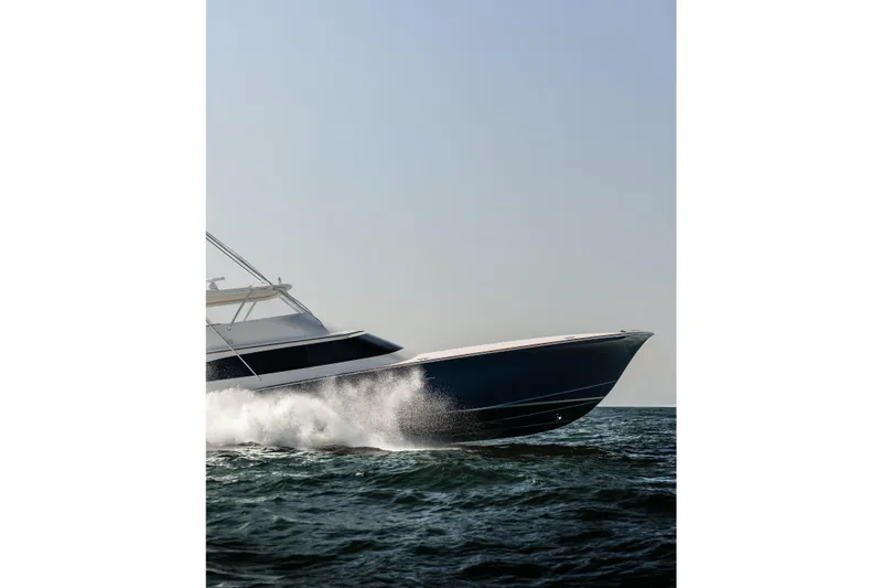 Slide: The Image of 2020 Jarrett Bay 84 yacht cruising swiftly on open water. - 14