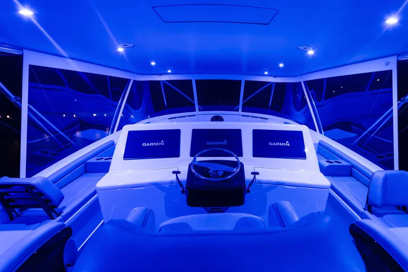 Slide: The Image of Cockpit of 2020 Jarrett Bay 84 yacht with blue ambient lighting and Garmin displays. - 39
