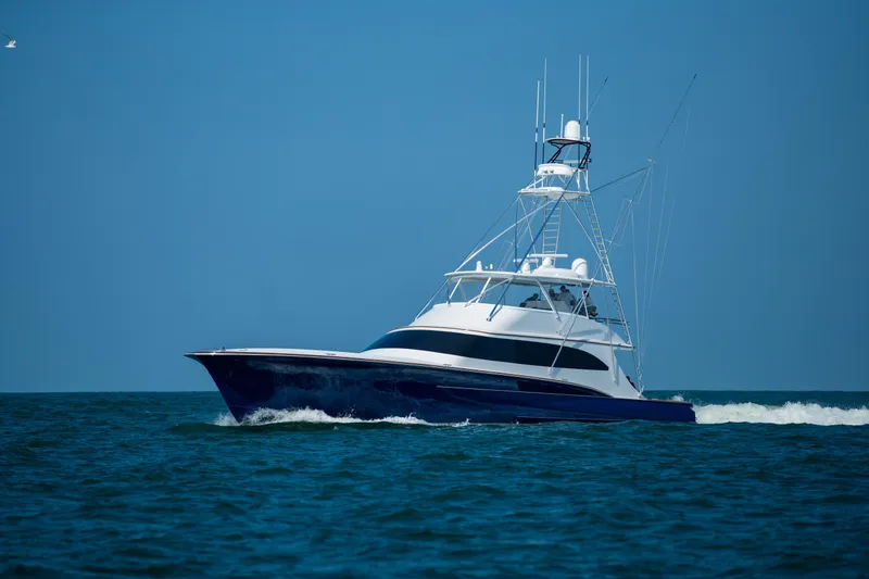 Slide: The Image of 2020 Jarrett Bay 84 yacht cruising on open sea under clear blue sky. - 6
