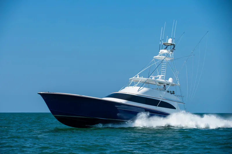 Slide: The Image of Luxury 2020 Jarrett Bay 84 yacht cruising on open sea under clear blue sky. - 7