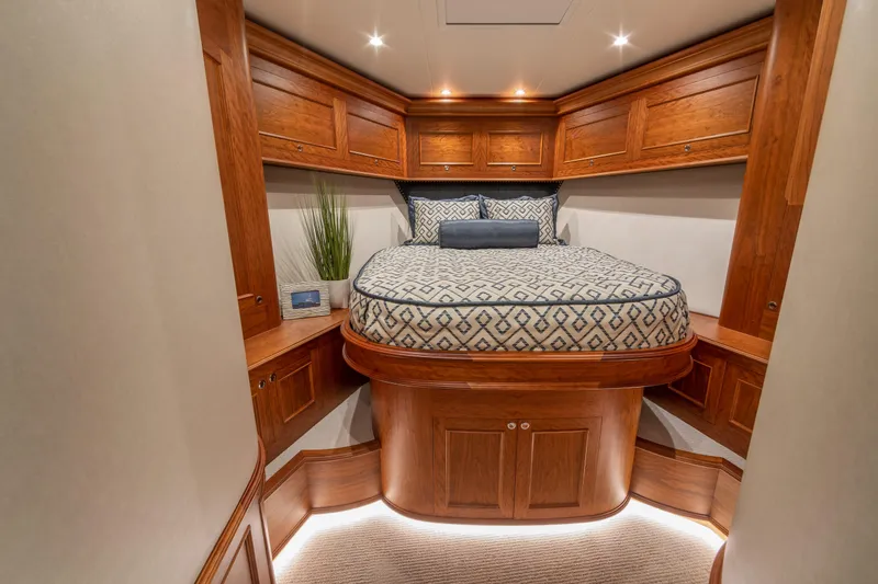 Slide: The Image of Luxurious cabin interior of 2020 Jarrett Bay 84 yacht with elegant wood finish and cozy bedding. - 72