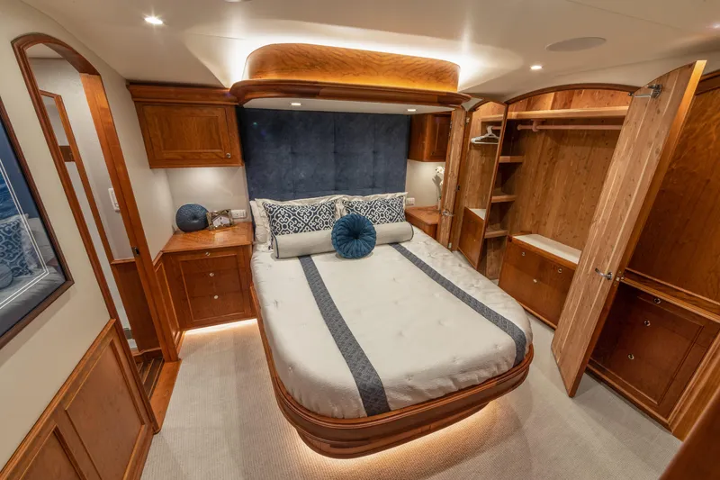 Slide: The Image of Luxurious bedroom interior of 2020 Jarrett Bay 84 yacht with elegant wood finishes. - 81