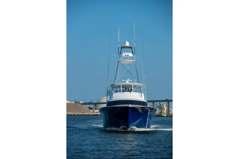 Slide: The Image of 2020 Jarrett Bay 84 yacht cruising on open water under clear blue sky. - 9