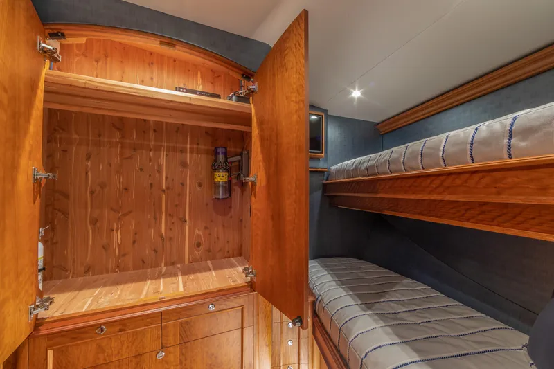 Slide: The Image of Luxurious 2020 Jarrett Bay 84 yacht interior with wooden closet and cozy bunk beds. - 91
