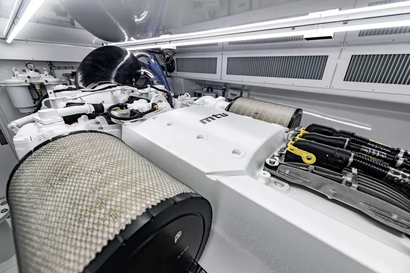 Slide: The Image of Engine room of 2020 Jarrett Bay 84 yacht, showcasing advanced MTU engine components. - 96