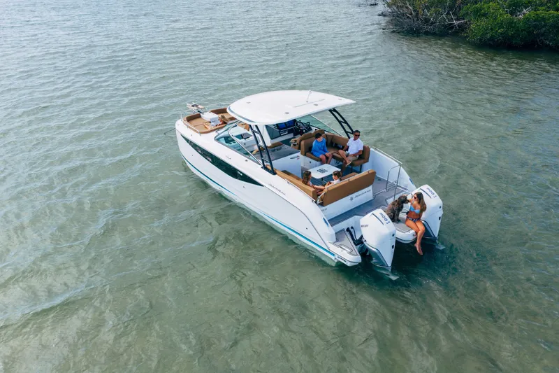 The Image of 2026 Jeanneau TH33 boat with passengers on calm water. - 0