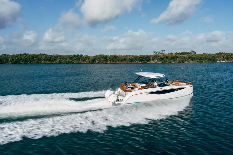 Slide: The Image of 2026 Jeanneau TH33 cruising on open water under a clear sky. - 4