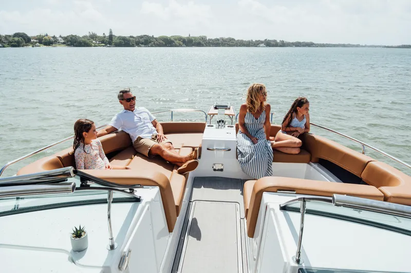 Slide: The Image of Family relaxing on 2026 Jeanneau TH33 boat, enjoying a sunny day on the water. - 9