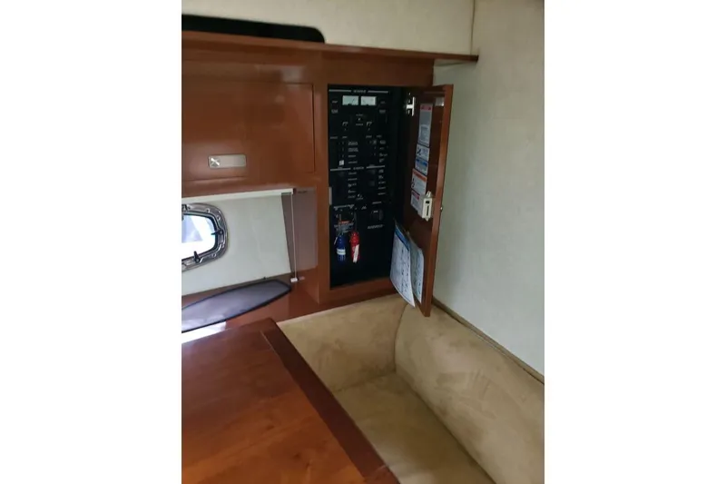 Slide: The Image of Interior of 2010 Sea Ray Sundancer 310 showing control panel and seating area. - 10