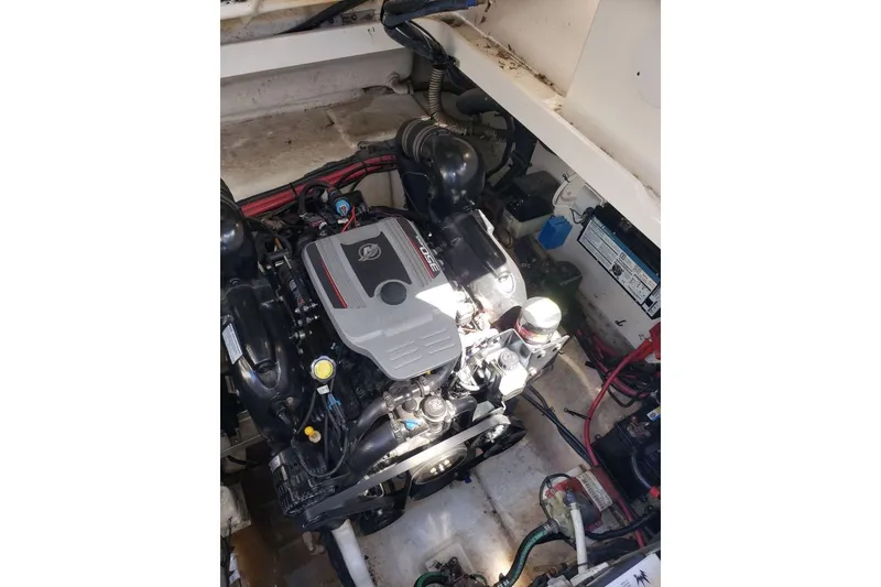 Slide: The Image of Engine compartment of a 2010 Sea Ray Sundancer 310 boat, showcasing the engine details. - 11