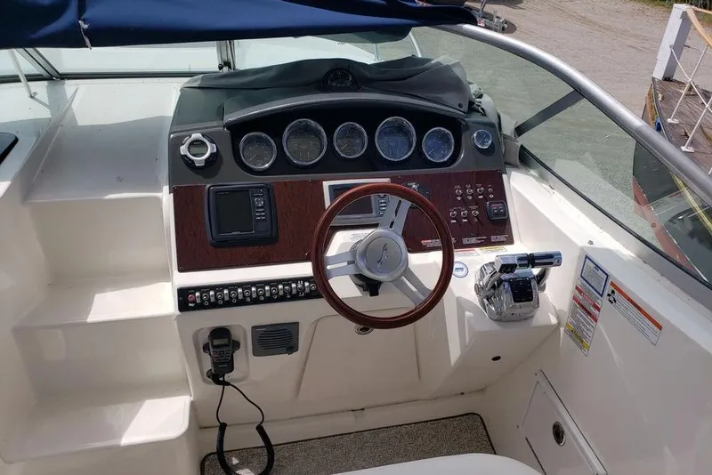 Slide: The Image of Cockpit of 2010 Sea Ray Sundancer 310 with steering wheel and control panel. - 3