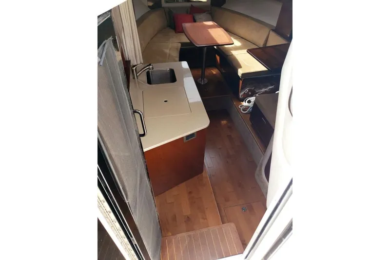 Slide: The Image of Interior of 2010 Sea Ray Sundancer 310 yacht with kitchenette and seating area. - 5
