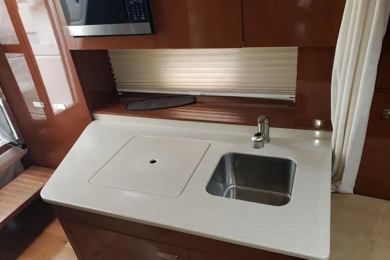 Slide: The Image of 2010 Sea Ray Sundancer 310 yacht kitchen with sink and microwave. - 6