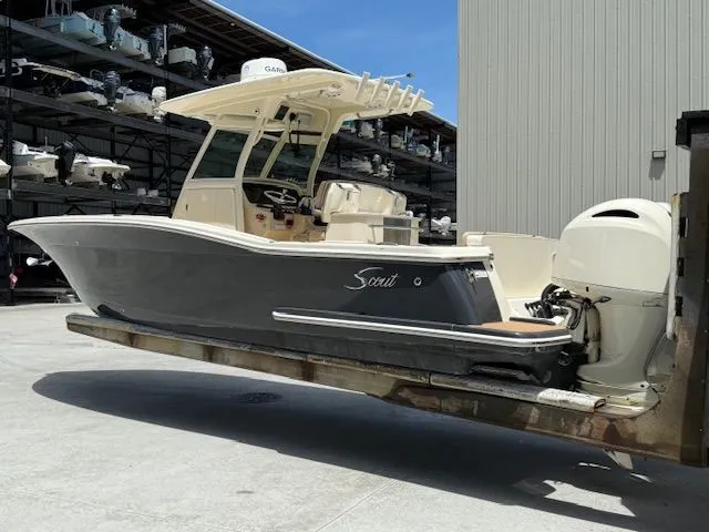The Image of 2017 Scout 275 LXF boat on trailer outdoors. - 0