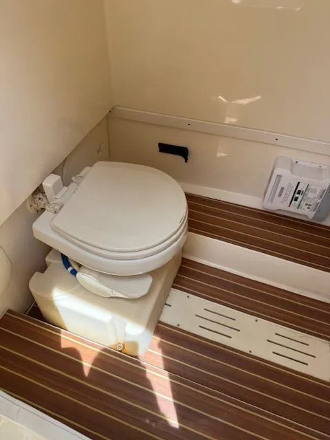 Slide: The Image of Interior of 2017 Scout 275 LXF featuring toilet and wood flooring. - 15