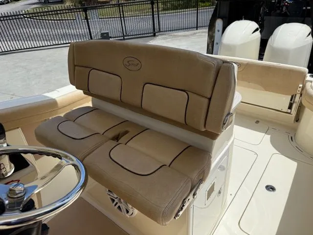 Slide: The Image of Interior of a 2017 Scout 275 LXF boat with beige leather seats. - 17